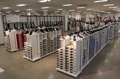 the inside of a shoe store with lots of shoes on display