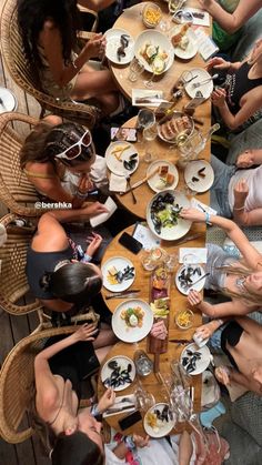 a group of people sitting around a table eating food