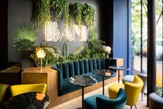 the interior of a restaurant with plants on the wall