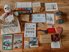 the contents of a father christmas gift bag laid out on top of a wooden table