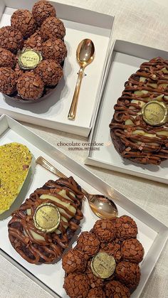 three trays with different types of cookies and spoons on top of each one