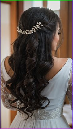 a woman with long hair wearing a tiara