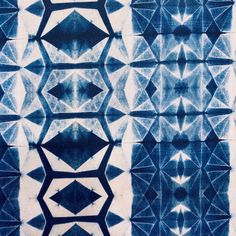 a blue and white tie - dye pattern with diamond shaped shapes on it's surface