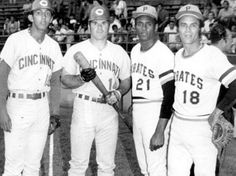 three baseball players are posing for a photo in front of the stands with their bats