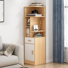 a living room with a couch, chair and bookshelf in front of a window