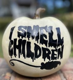 a white pumpkin with the words smile children painted on it