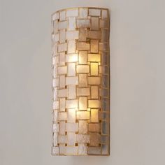 a wall light that is mounted to the side of a wall with glass blocks on it