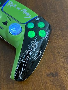 a close up of a video game controller on a wooden table with writing on it