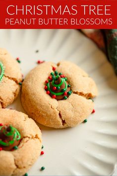 three christmas tree peanut butter blossoms on a white plate