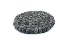 a round object made out of felt on a white background