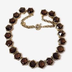 This is a Talbots hexagon shaped, faceted brown crystal necklace--a perfect blend of classic sophistication and contemporary charm. This necklace features a stunning array of 21 brown crystal set in a gold tone setting. The warm, earthy tones of the brown crystals add a touch of richness to any outfit, while the unique hexagonal shape and faceted finish catch the light for a subtle sparkle. Measures 21"l. and finished with a spring ring clasp. No damage or missing stones. Brown Crystals, Custom Jewellery, Jewellery Ideas, Crystal Set, Hexagon Shape, Earthy Tones, Gold Jewellery, Stone Necklace, Spring Rings