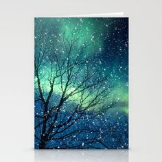 a card with an image of trees and the aurora bore in the sky on it