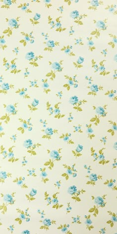 a blue flowered fabric with green leaves and flowers on white background, closeup