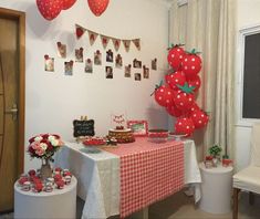 a table topped with lots of red balloons