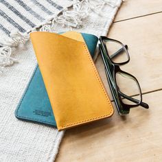 a pair of glasses sitting on top of a wallet