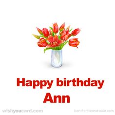 a vase filled with red flowers on top of a white table next to a sign that says, happy birthday michigan