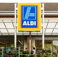 an aldi store front with flowers in the foreground