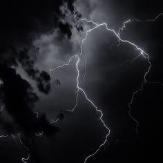 a black and white photo of lightning in the sky