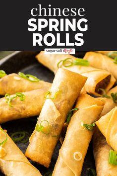 chinese spring rolls on a plate with green onions