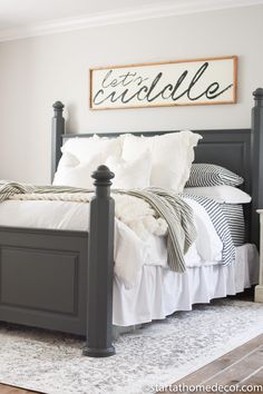 a bed with white sheets and black posts