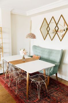 a dining room table with chairs and a rug