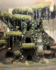 a fake tree house made out of moss and flowers