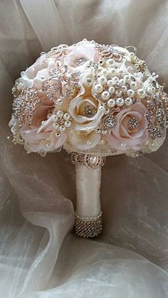 a bridal bouquet with pearls and roses