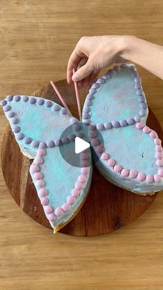 a cake shaped like a butterfly with pink and blue icing