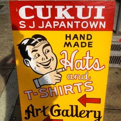 a yellow sign with a man pointing at it's shirt and the words art gallery on it