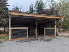 a horse barn with two stalls in the middle