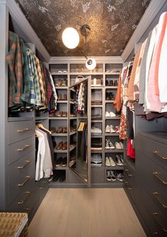 a walk in closet filled with lots of clothes