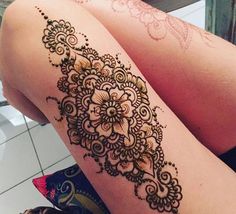 a woman's legs with henna tattoos on them