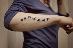 a woman's arm with birds on it