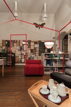 a living room filled with lots of furniture and decor