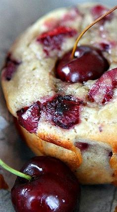 a cherry muffin with some cherries on it