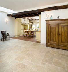 a large kitchen and dining room with tile flooring