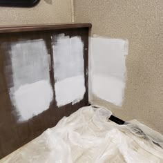 some white paint is being applied on the wall