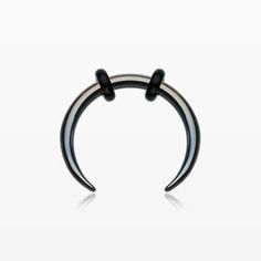 an oxen nose ring with black and white stripes on the outside, set against a white background