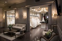 a wedding dress shop with white dresses and chandeliers