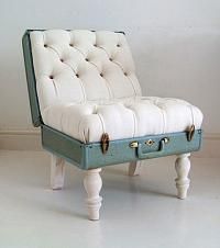 an upholstered bench with buttons on the back and legs is shown in front of a white wall