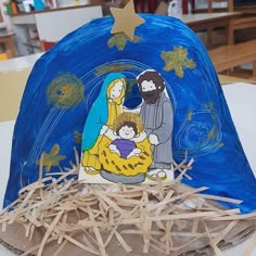 the nativity scene is made out of paper and wood sticks, along with other crafting supplies