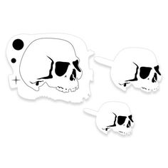 three skull stickers are shown in black and white, one is half - turned to the