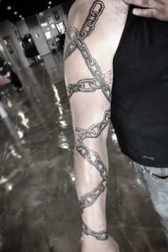 a man with a chain tattoo on his arm