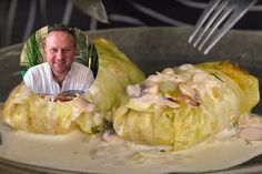 a man sitting in front of some food on a pan with a fork sticking out of it