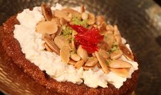 a cake with nuts and cream on top