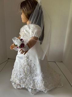 a doll wearing a wedding dress and veil