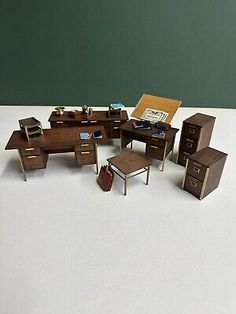 a collection of miniature desks and chairs