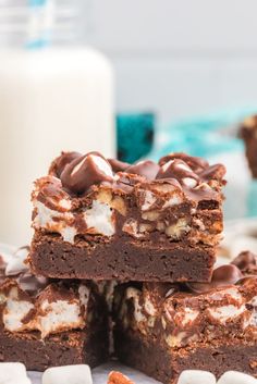 chocolate marshmallow brownies stacked on top of each other with marshmallows around them