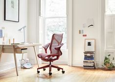 an office area with a desk, chair and bookshelf in the corner on top of hard wood flooring