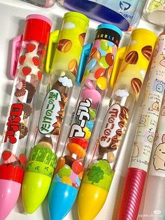 several different types of candy pens lined up in a row